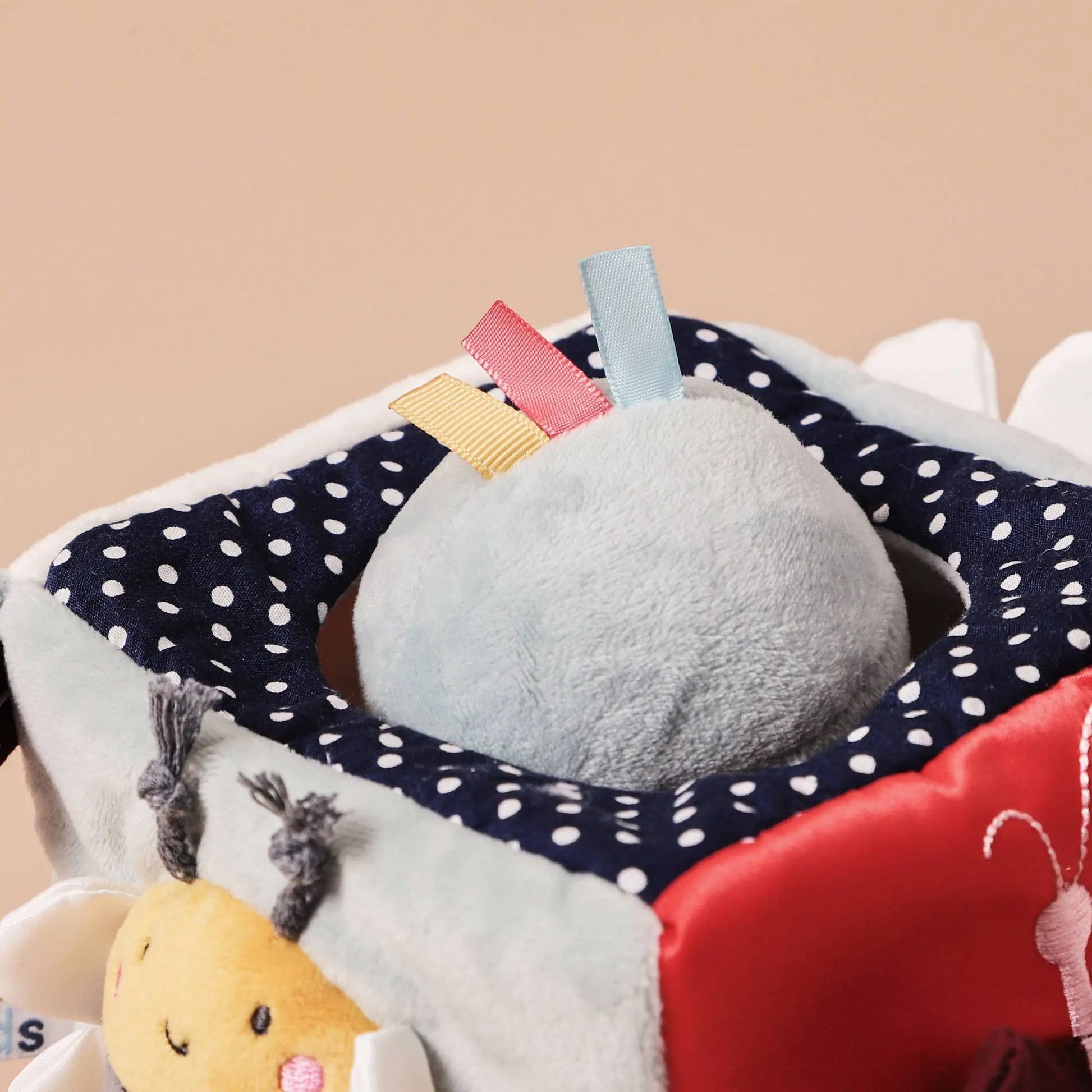 Close-Up of Textured Details on the Cube – Showcasing raised patterns, embroidery, and soft fabric elements.