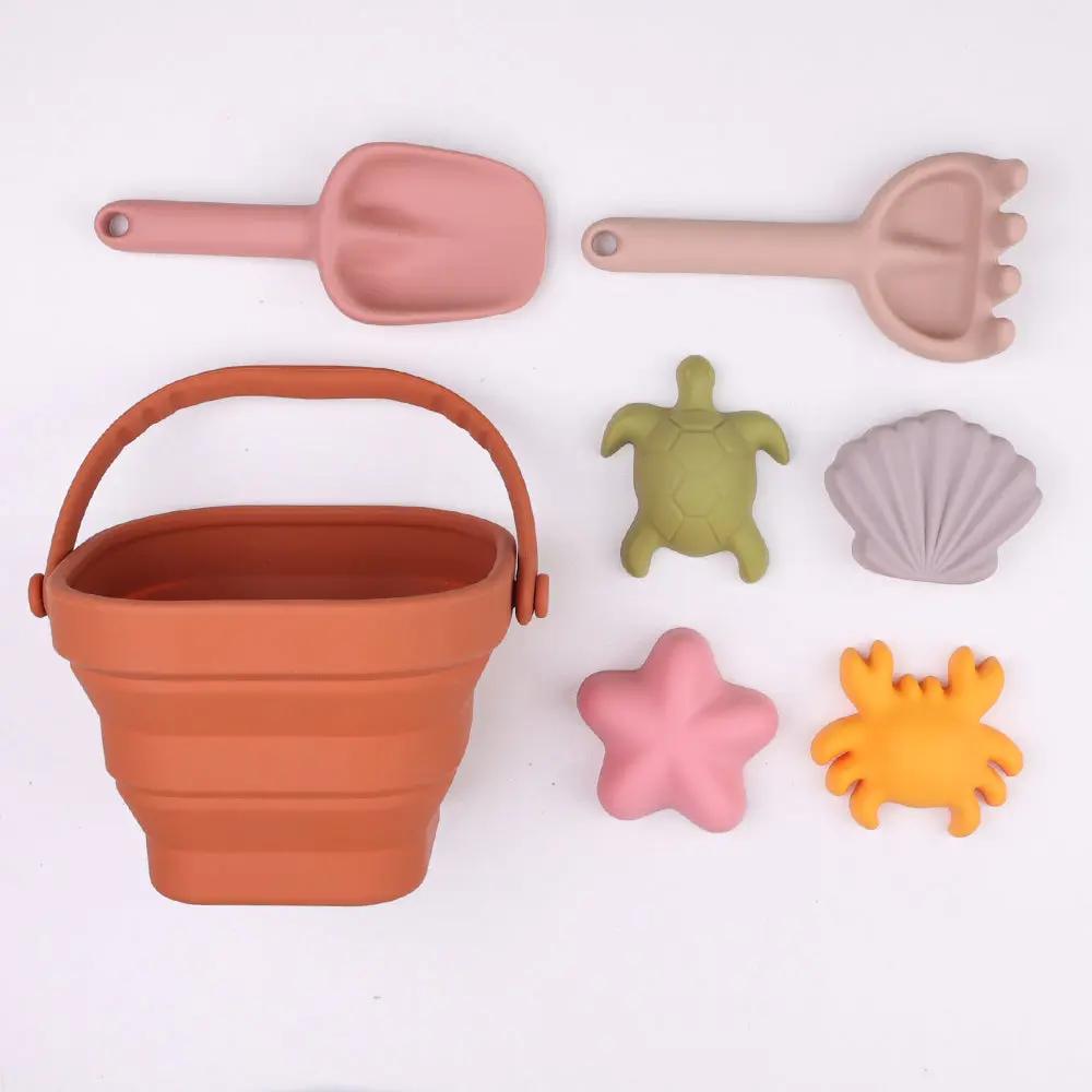 Collapsible silicone beach bucket set with spade, rake, and sand moulds