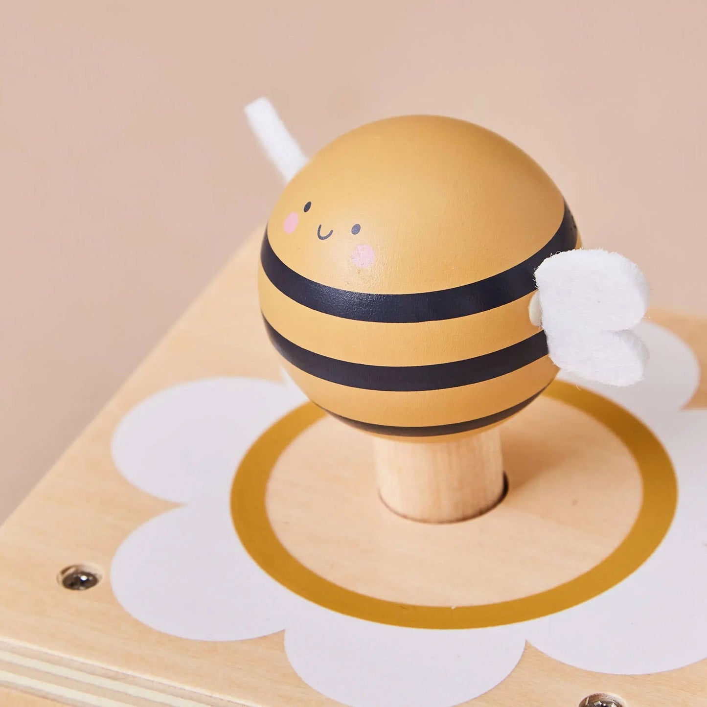 A closer look at the beautifully crafted wooden details and painted bee-themed design.