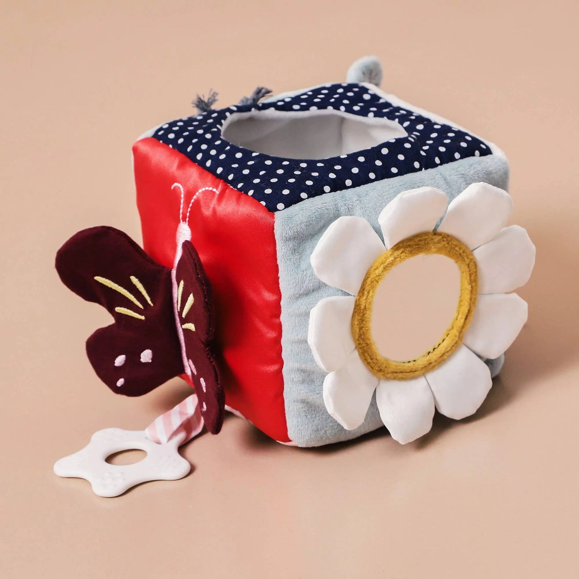 A of plush activity cubes featuring different textures, shapes, and designs.