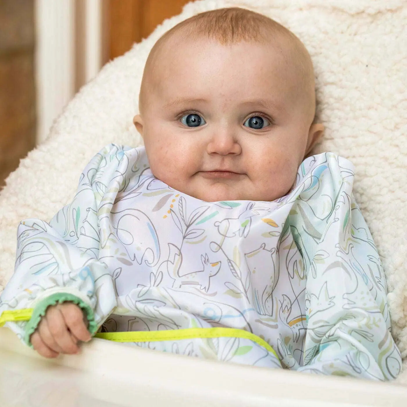 Child wearing sleeved bib during mealtime