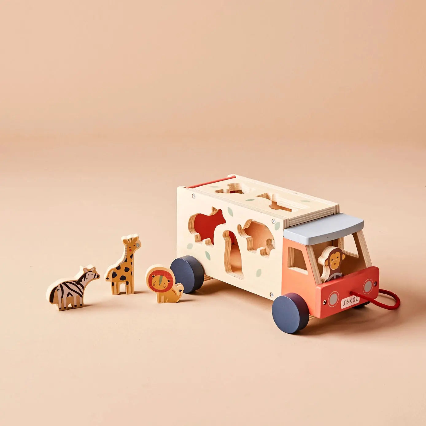 Wooden toy jeep with animal figures on a beige background