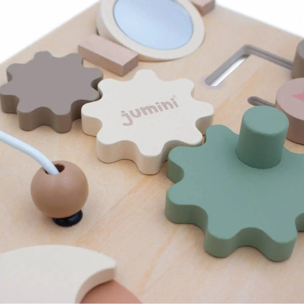 Children's toy with gears and tools on a white background, featuring the brand 'jumini'.