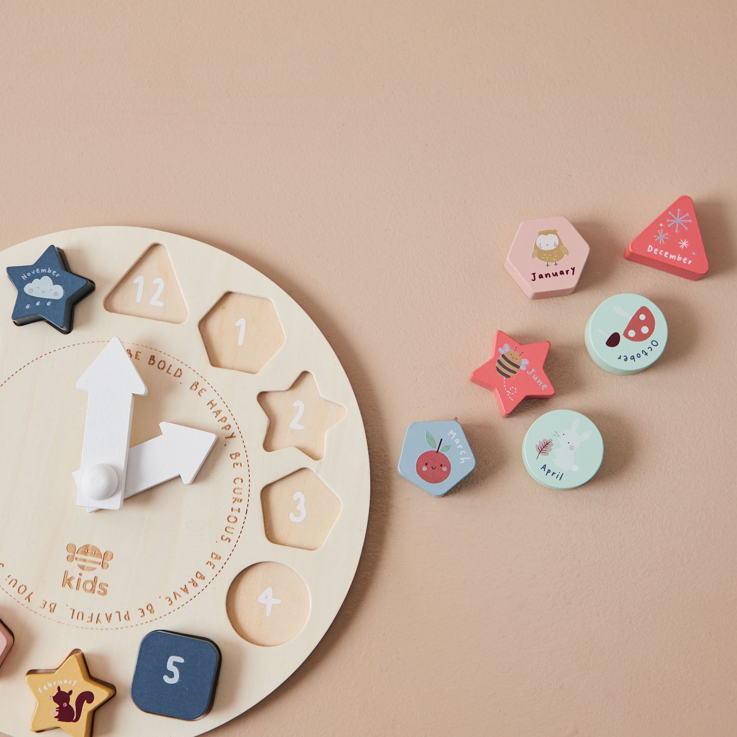Wooden educational clock toy with numbers and shapes on a beige background