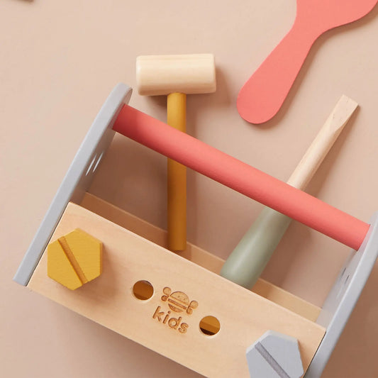 Colourful wooden tools with a 'just bee kids' logo on a beige background