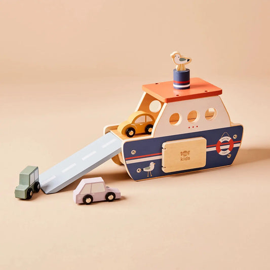 Wooden toy ferry with a small seagull on top, surrounded by cars on a beige background