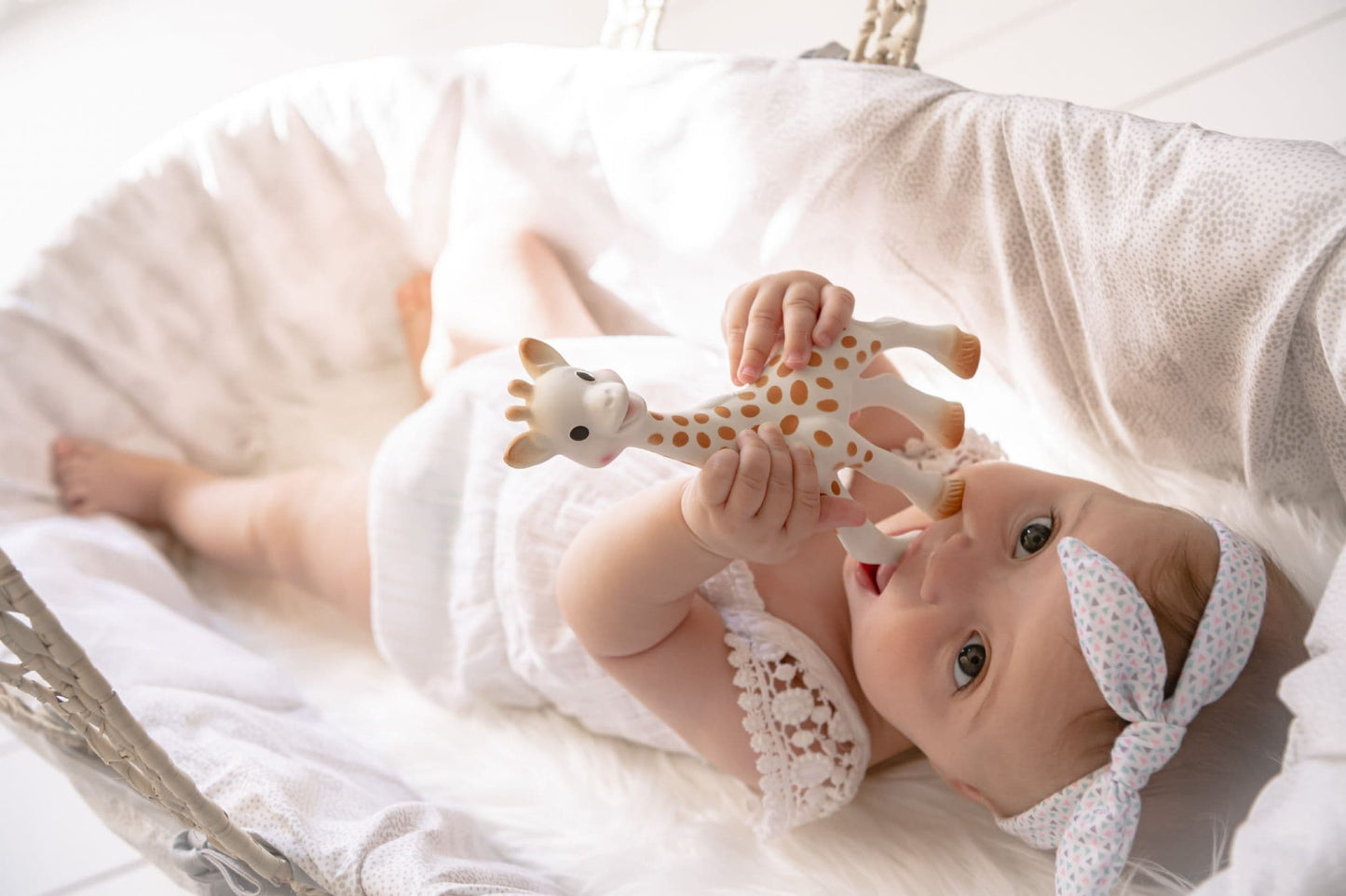 Baby playing with Sophie la Girafe teether