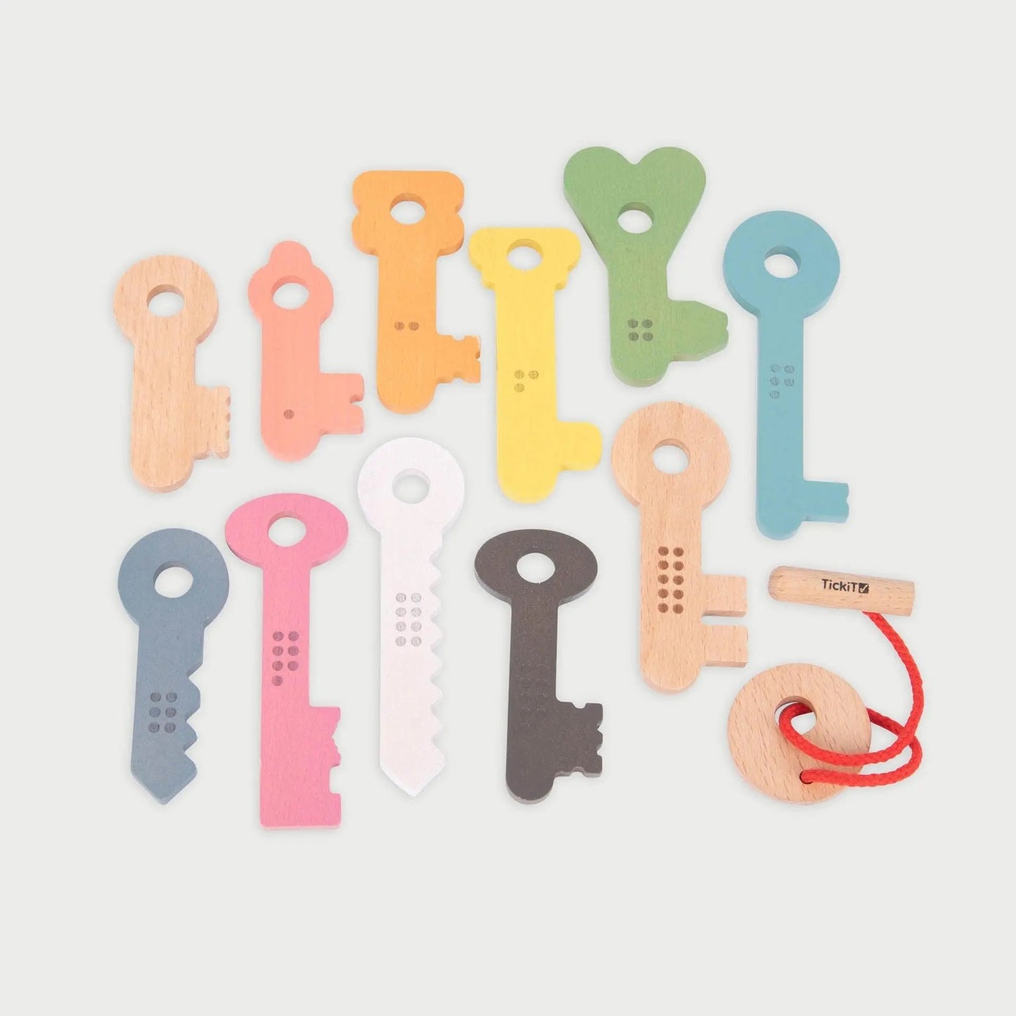 Set of colourful key-shaped toys on a light grey background