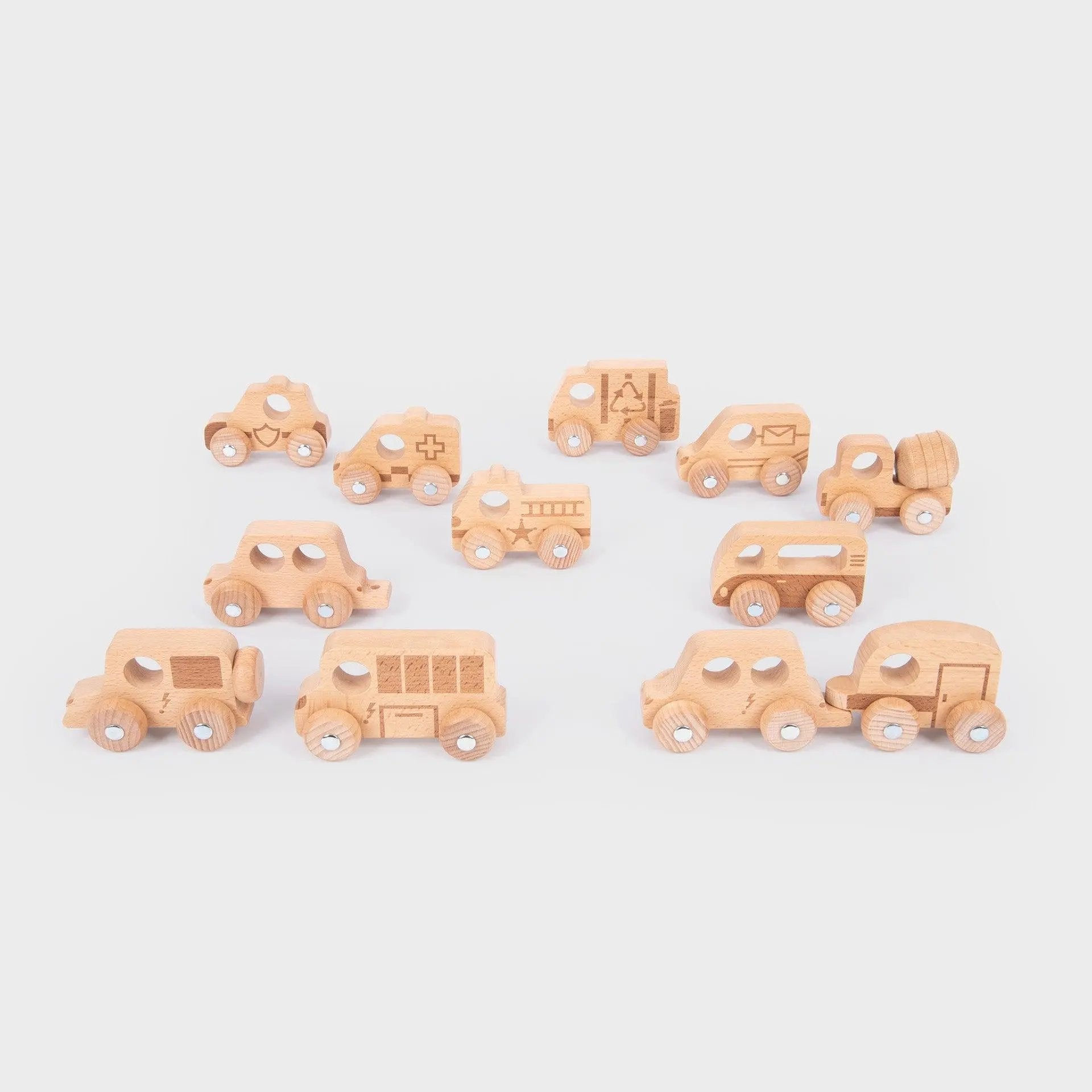 Set of small wooden toy cars on a light grey background