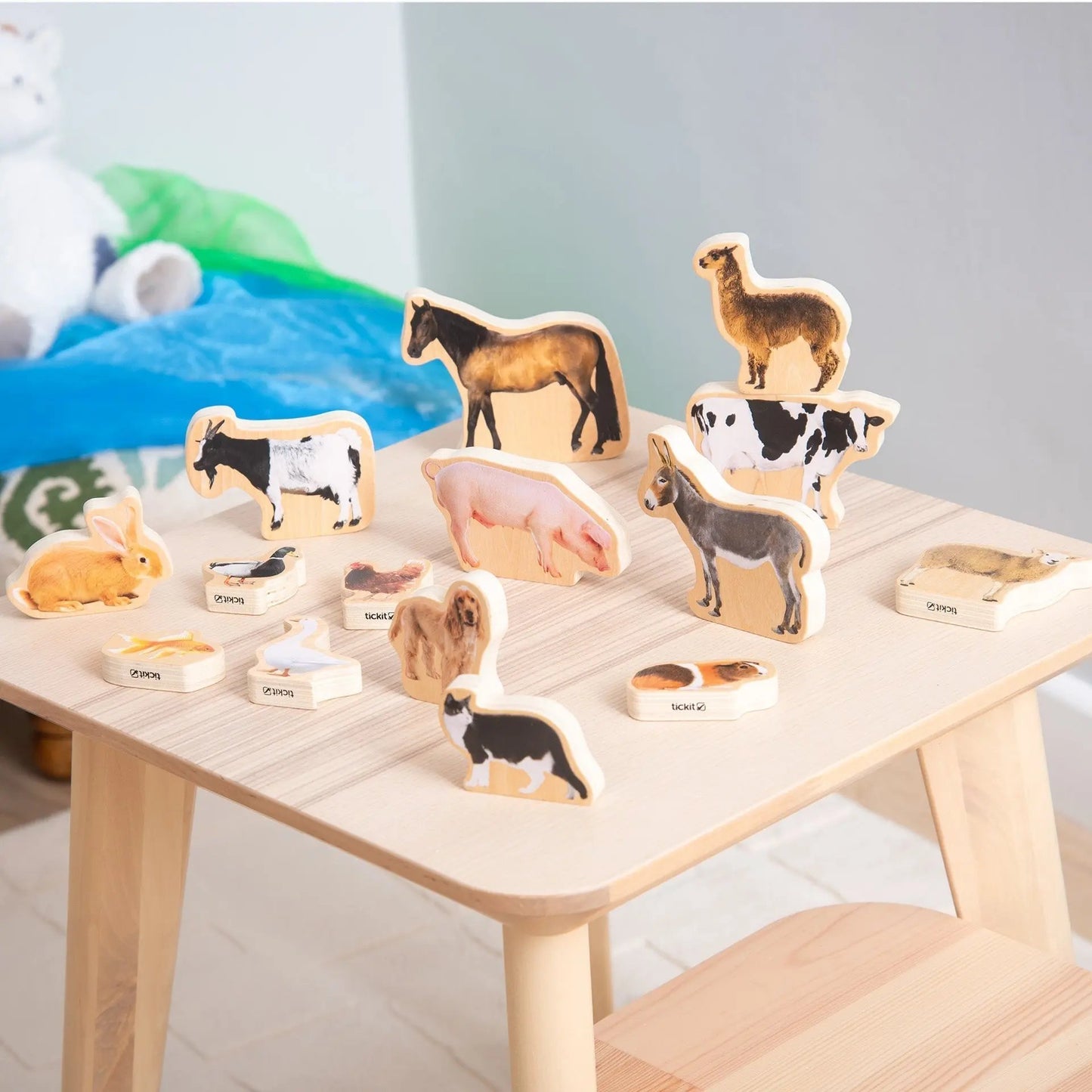 Wooden animal toys on a wooden table with a light background