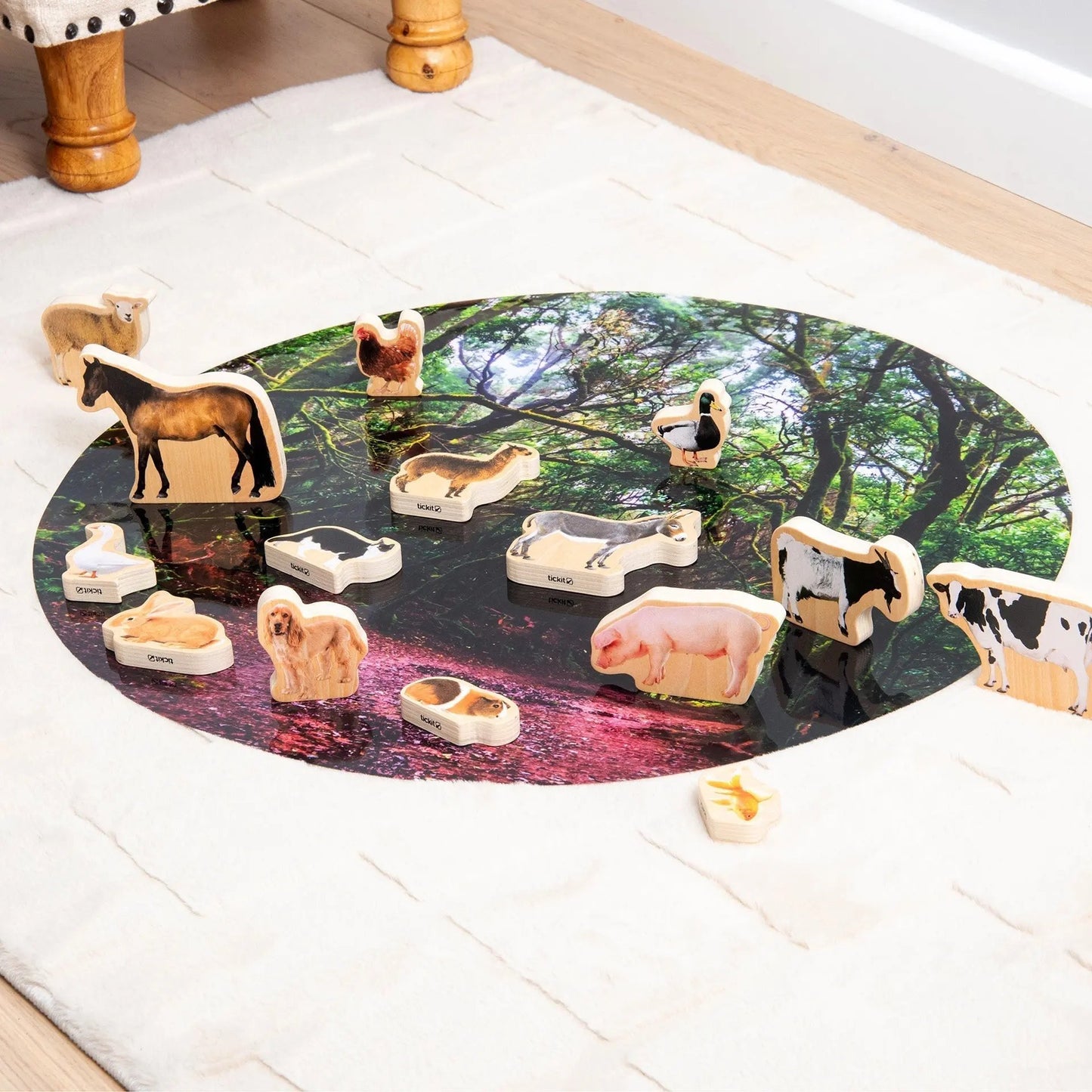 Round mat with animal figures on a white floor