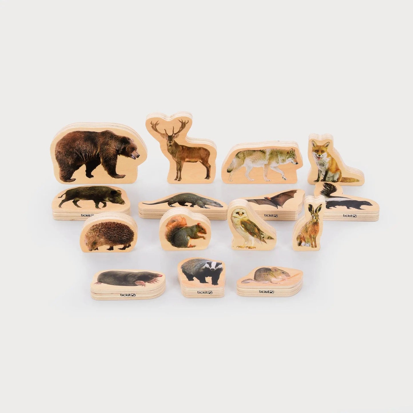 Set of wooden animal figurines on a white background