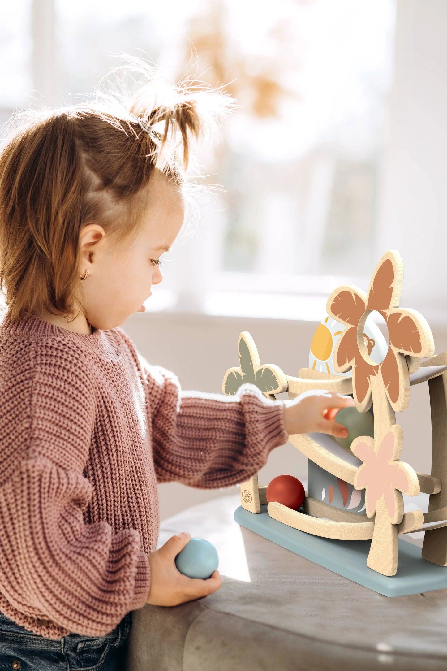 Toddler playing with Wooden Ball Ramp