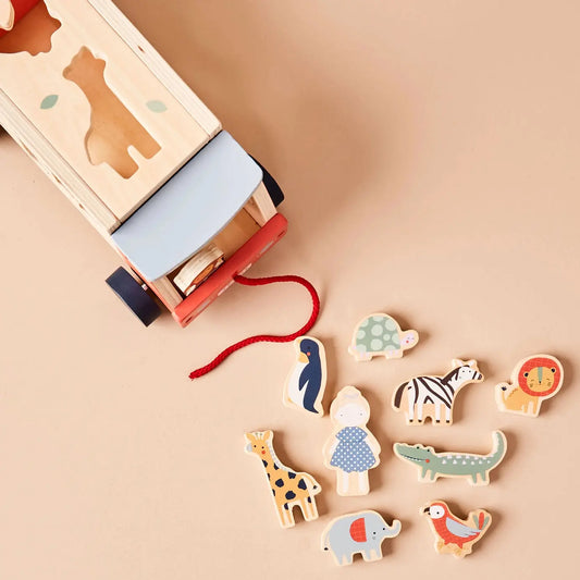 Wooden toy jeep with animal figures on a beige background