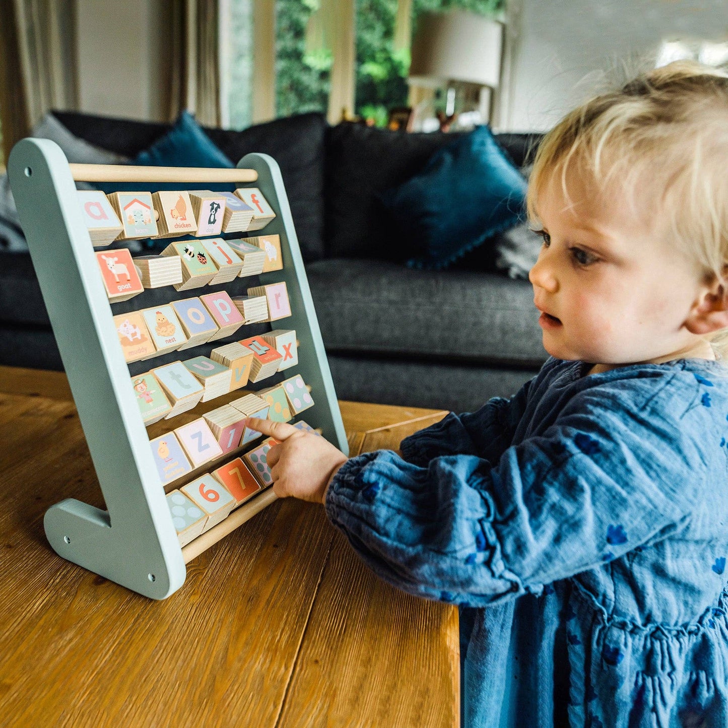 Child playing with Farm Animal Wooden Alphabet Abacus