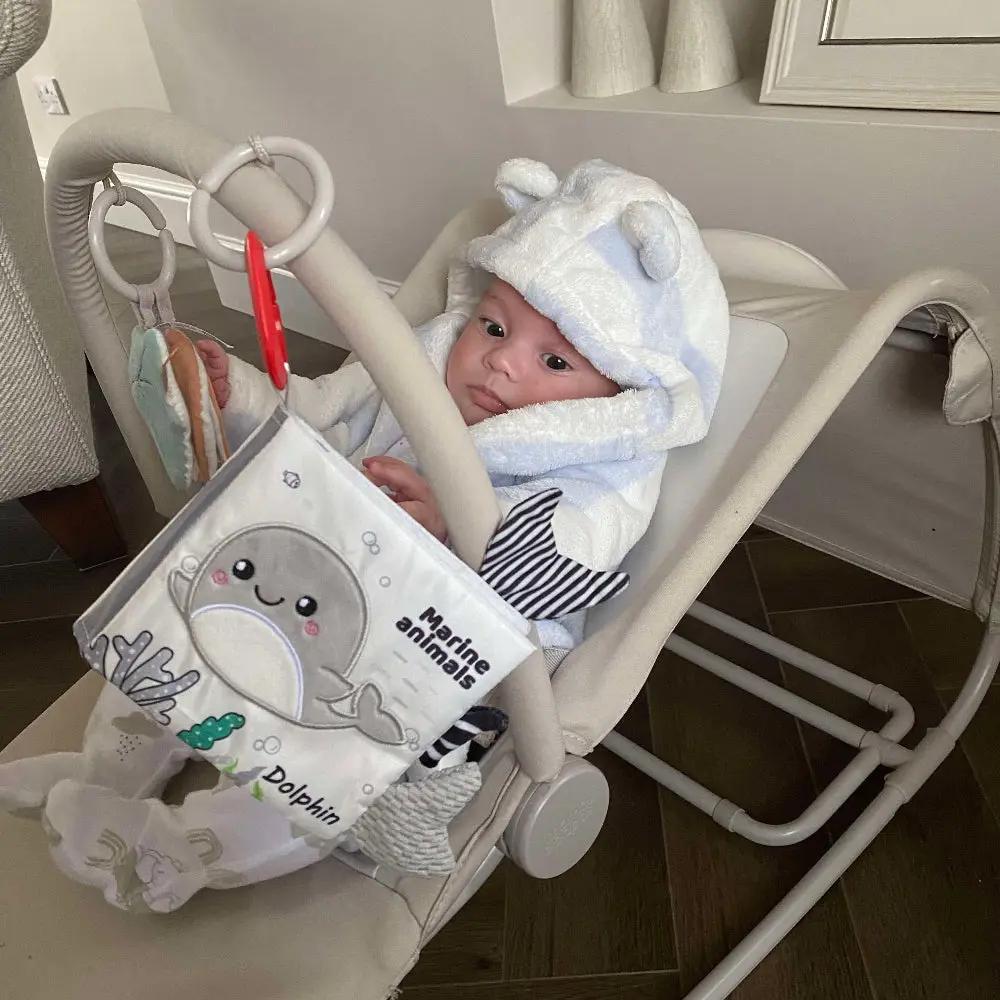 Baby playing with marine animals book