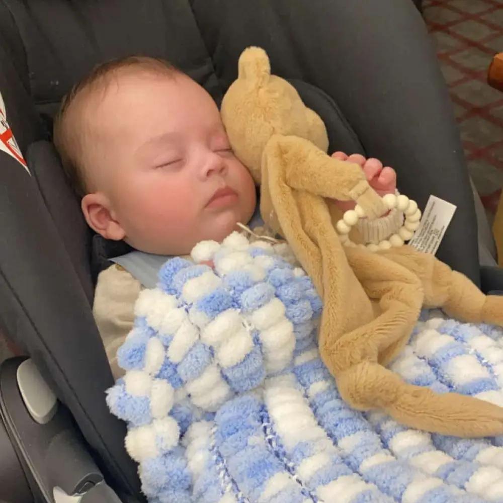 Baby sleeping with benni bear comforter