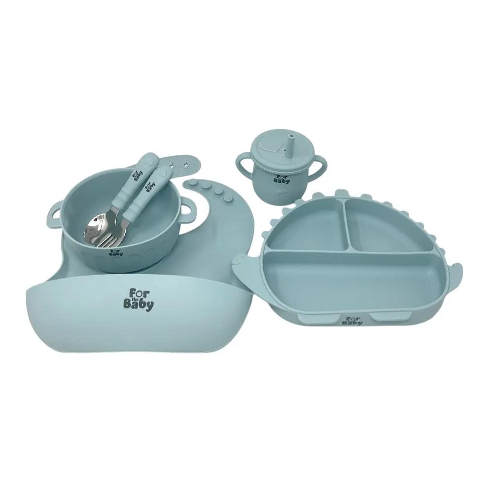 Blue silicone feeding set with suction plate, bowl, sippy cup, fork, spoon, and bib