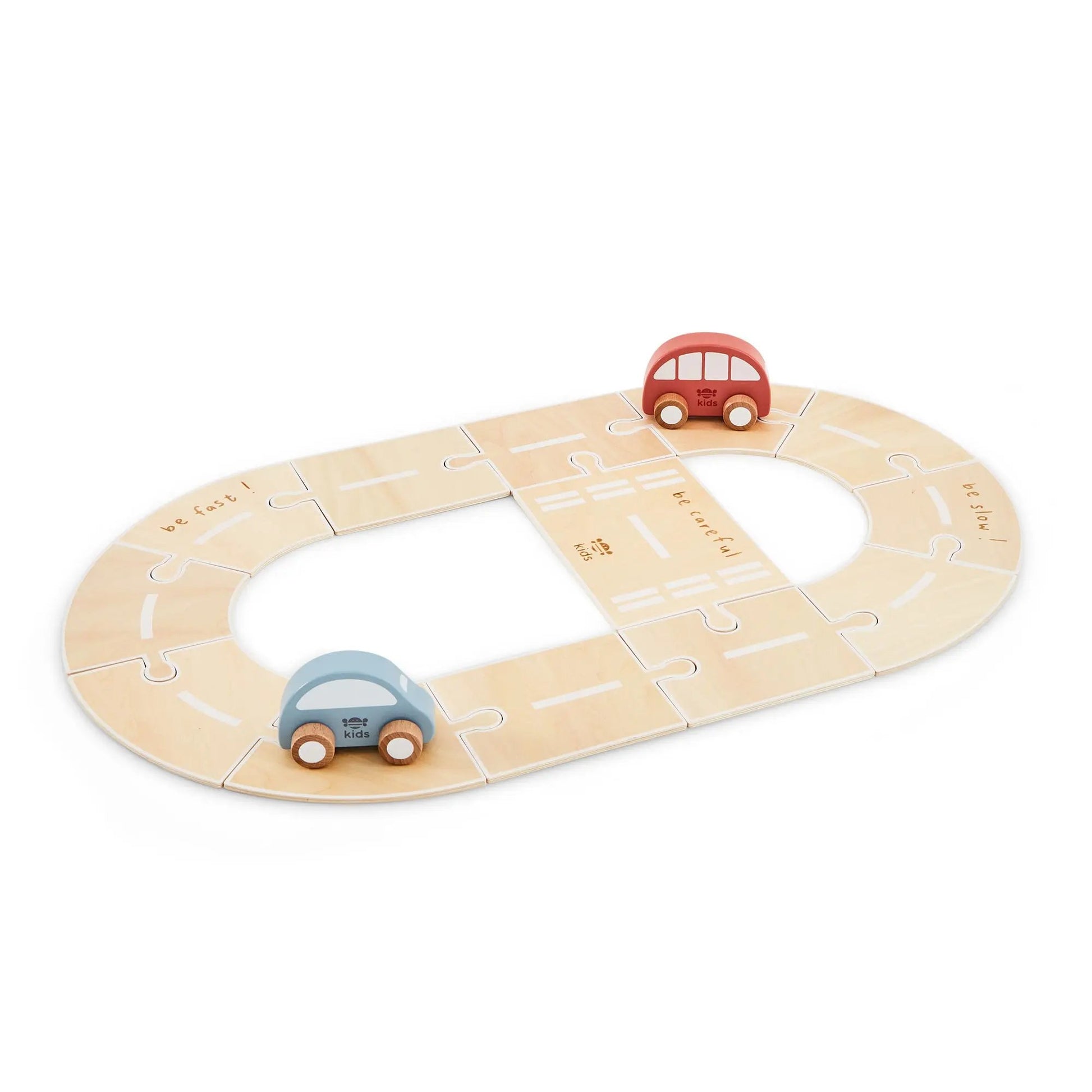 Wooden toy race track with two cars on a white background