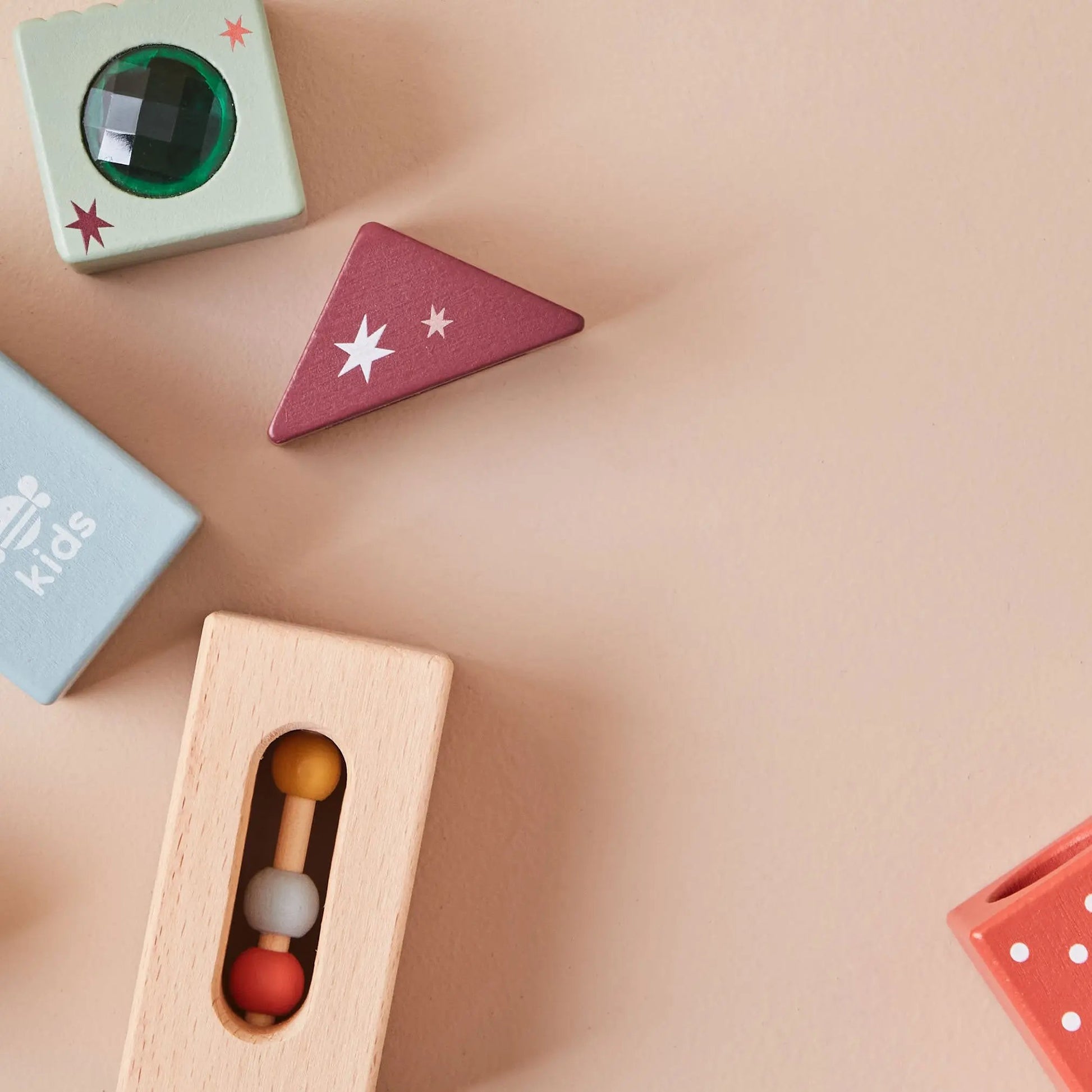 Colourful wooden toys on a beige surface