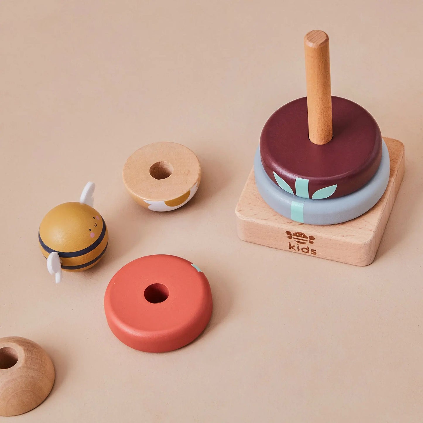 Set of colourful wooden toys on a beige background