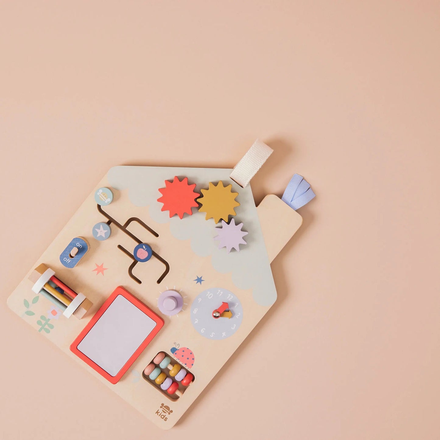 Colourful children's puzzle with various shapes and a whiteboard on a beige background