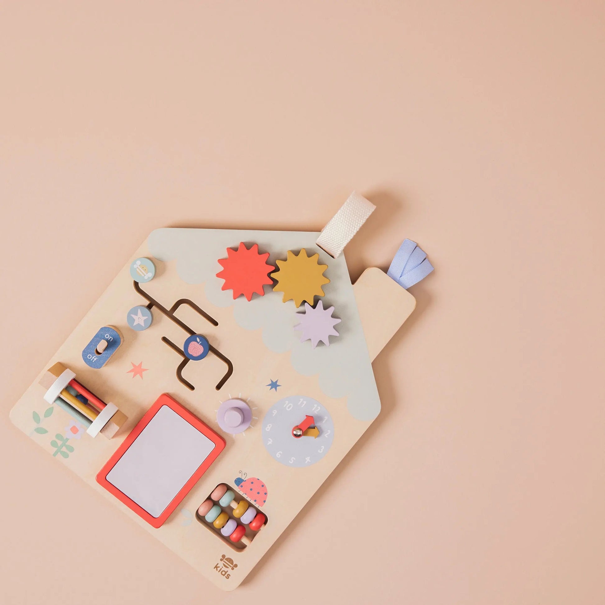 Colourful children's puzzle with various shapes and a whiteboard on a beige background