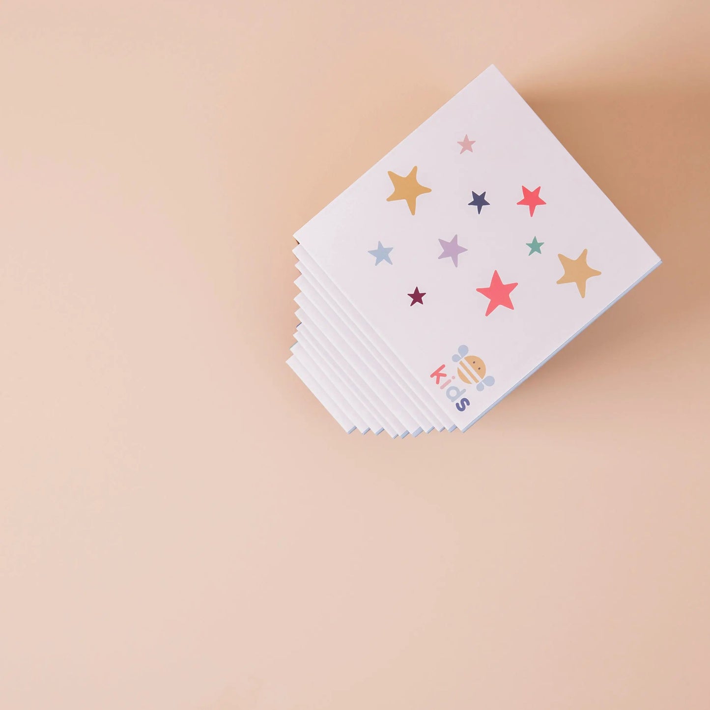 Stack of boxes with colourful star patterns on a beige background