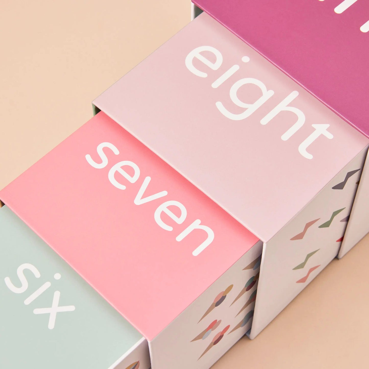 Colourful boxes with numbers 'six', 'seven', and 'eight' on a beige background