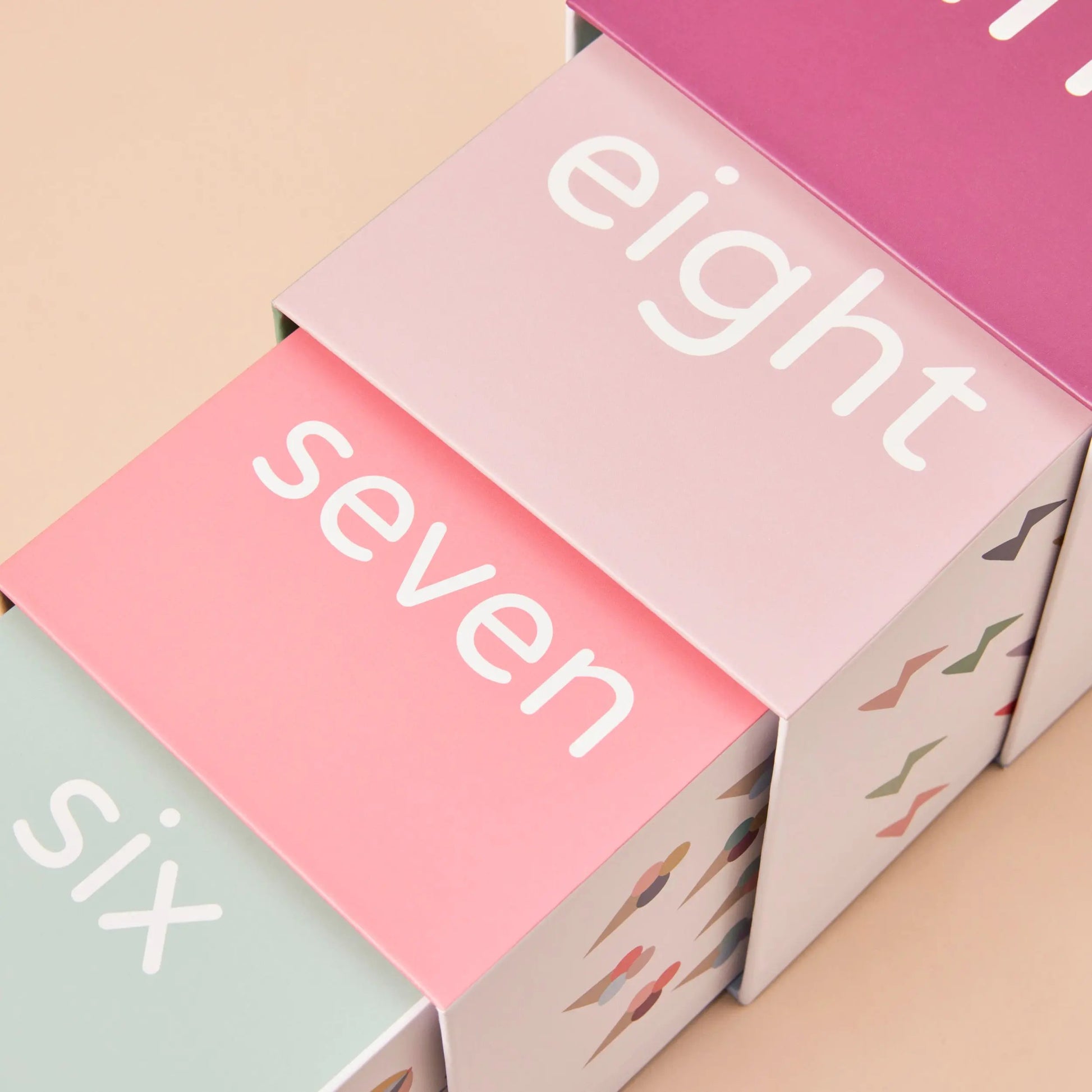Colourful boxes with numbers 'six', 'seven', and 'eight' on a beige background