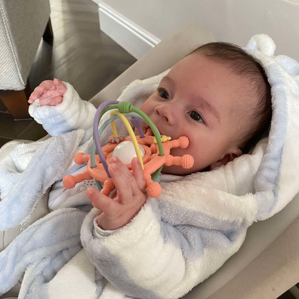 Silicone rattle being used as a teether