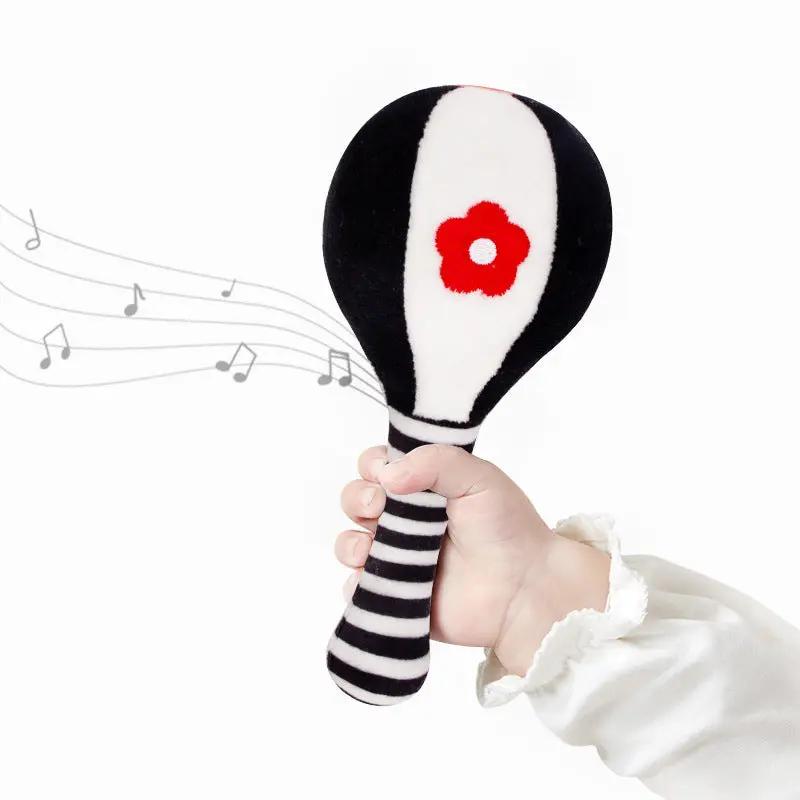 baby playing with rattle