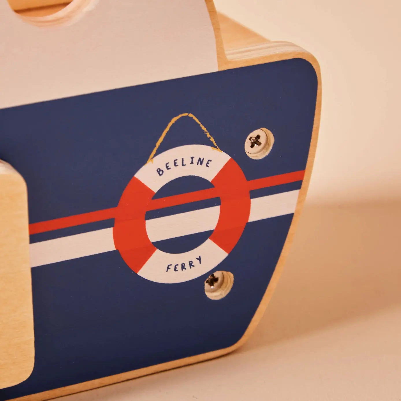 Close-up of a wooden ferry with a life buoy design and 'Beeline Ferry' text on a blue background.