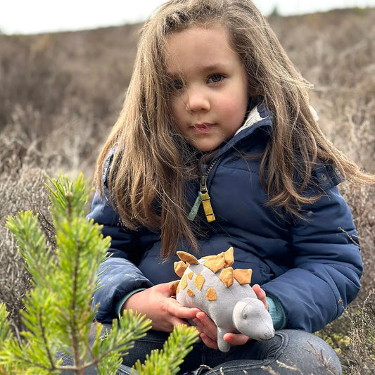 Steggy dinosaur with girl holding