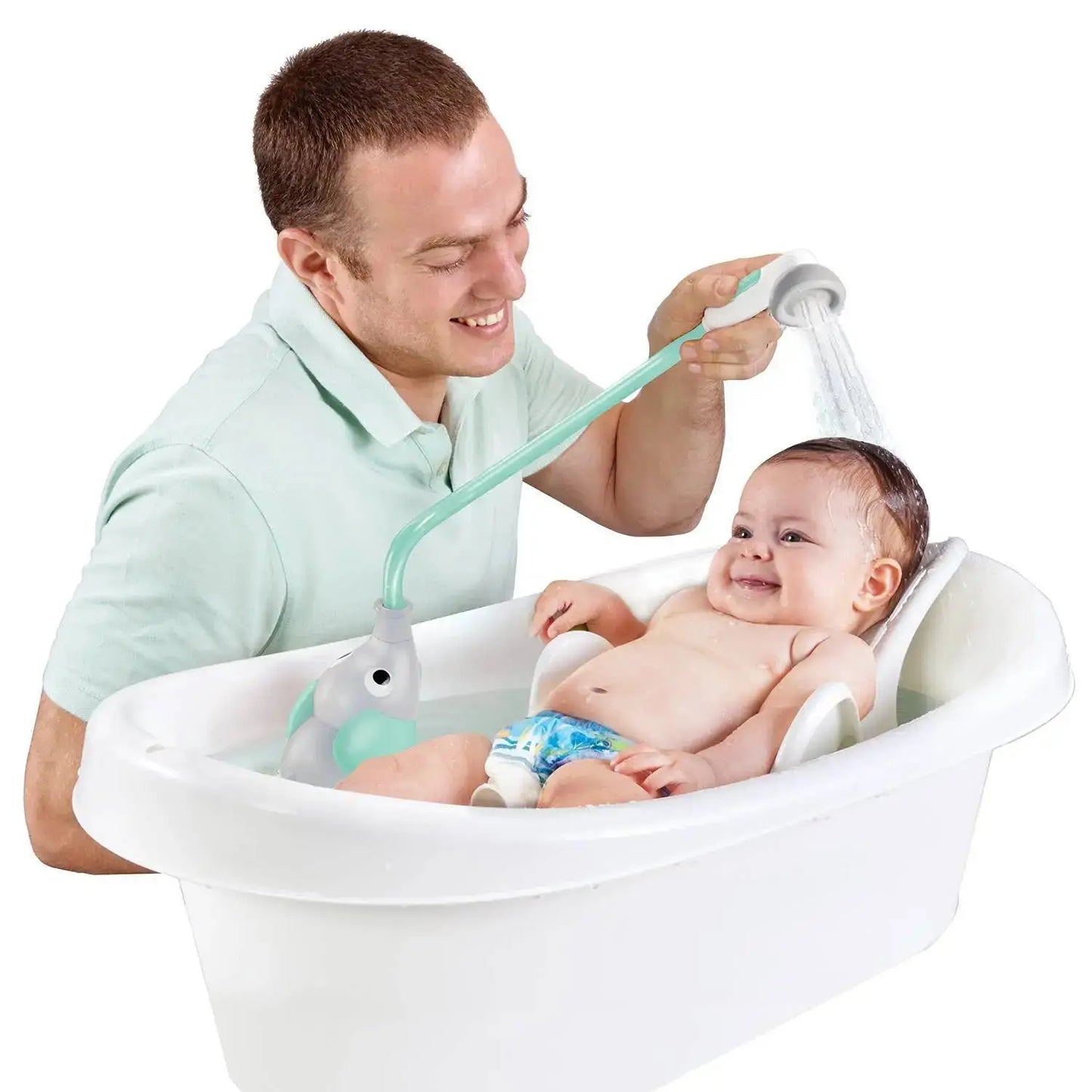 Man bathing a baby in a white bathtub with a green shower head attachment.