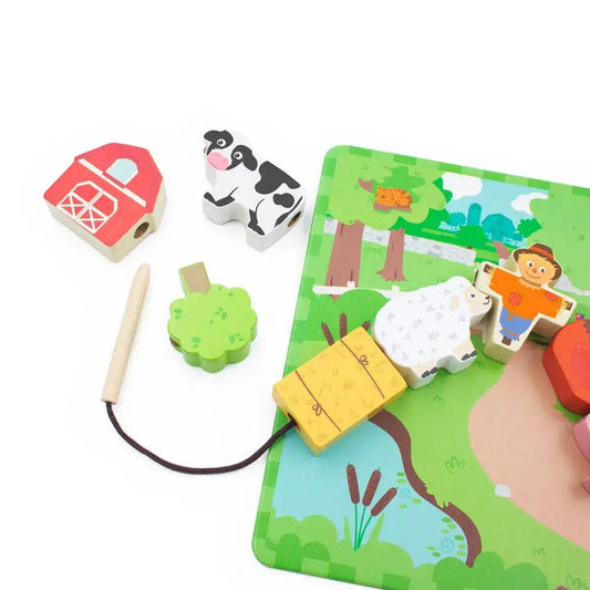 Wooden farm-themed puzzle with animals and a barn on a green base.