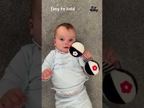 Baby plays with maraca rattle