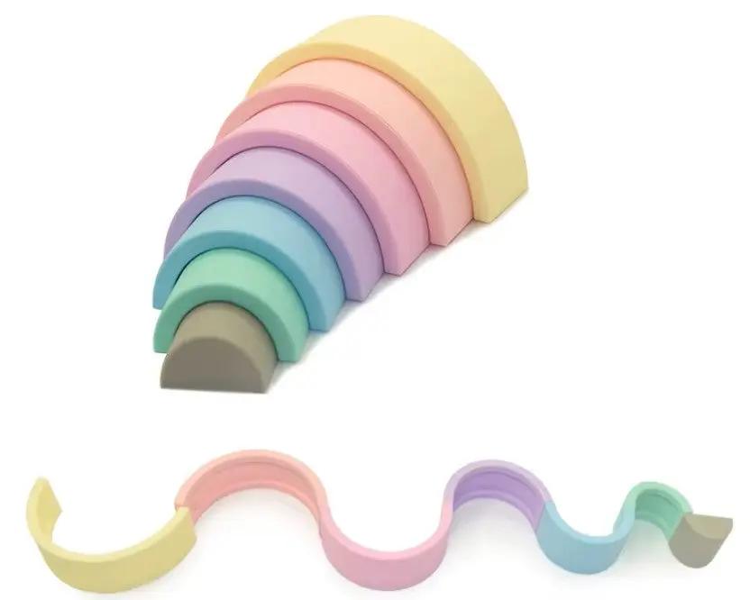 Stacked silicone rainbow toy promoting motor skill development.