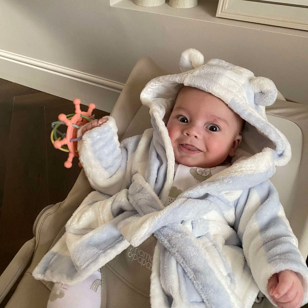 baby holding silicone rattle
