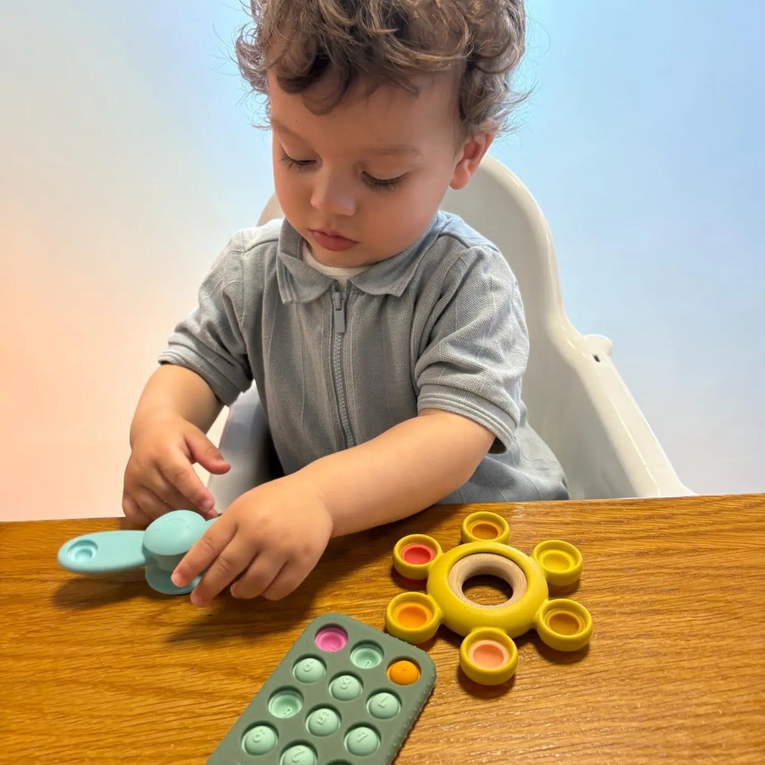 Toddler playing with popper toys