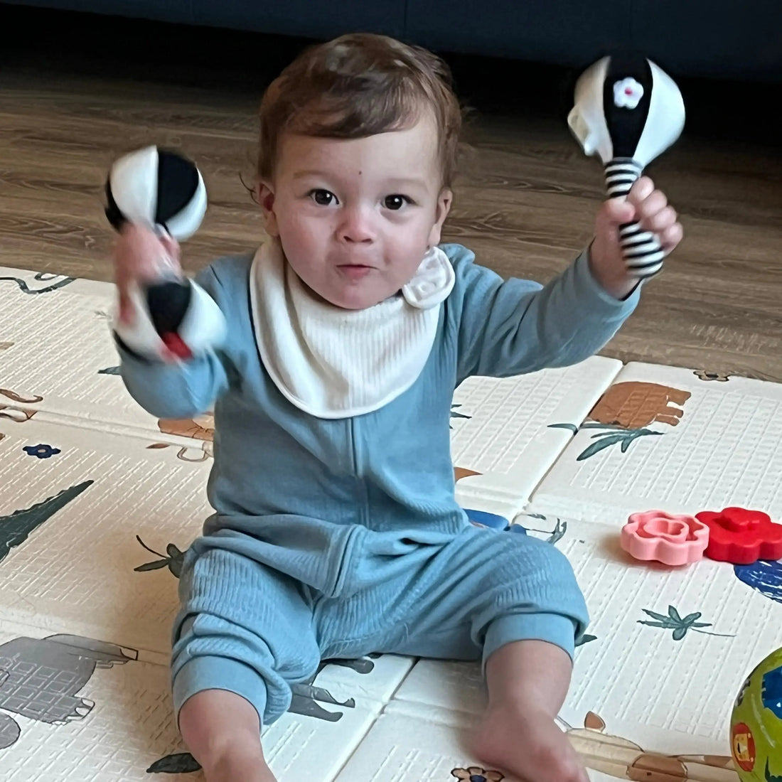 Baby holding rattles