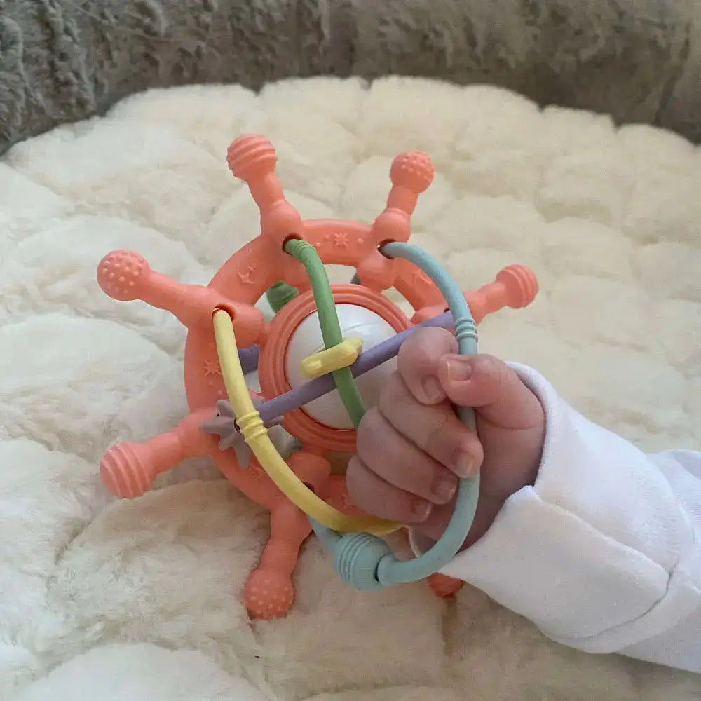 baby hand holding rattle