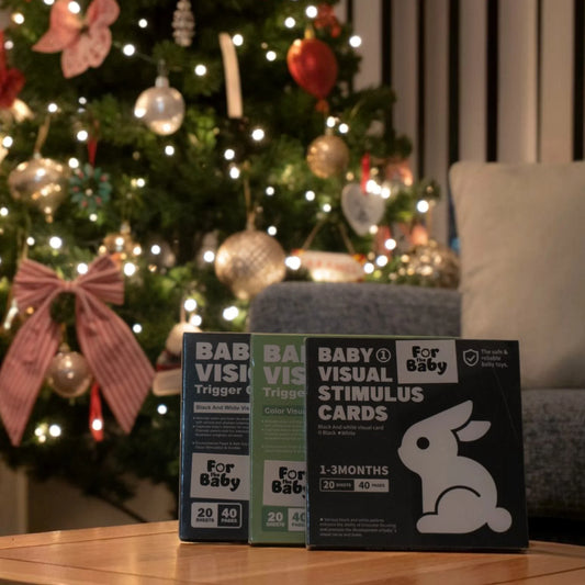 Baby flash cards beside Christmas Tree