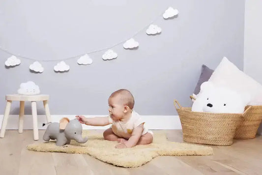 Baby playing with toy elephant