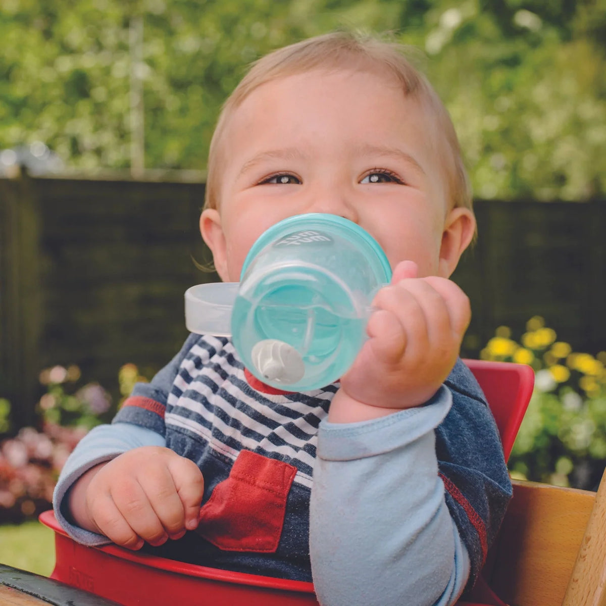 Small child sipping from a sippy cup