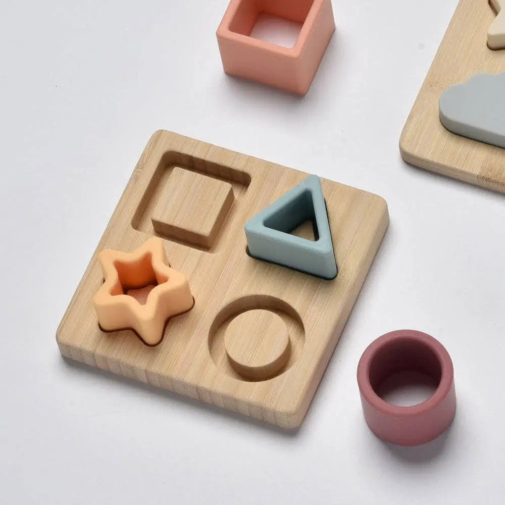 Wooden shape sorting toy with colourful geometric shapes on a light background