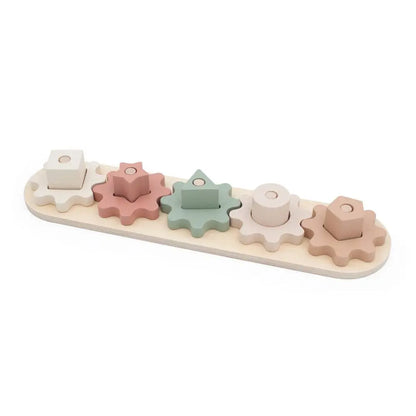 Pastel-coloured wooden toy with gears on a white background