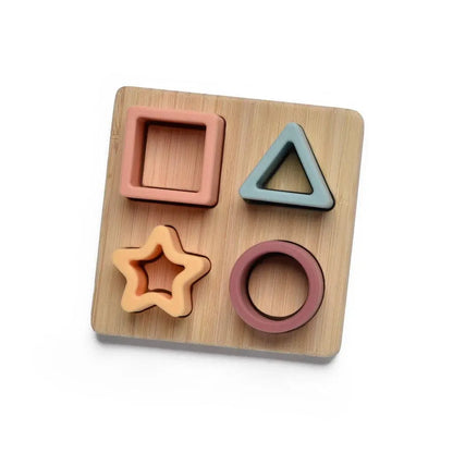 Wooden shape sorting toy with square, triangle, circle, and star shapes on a wooden board.