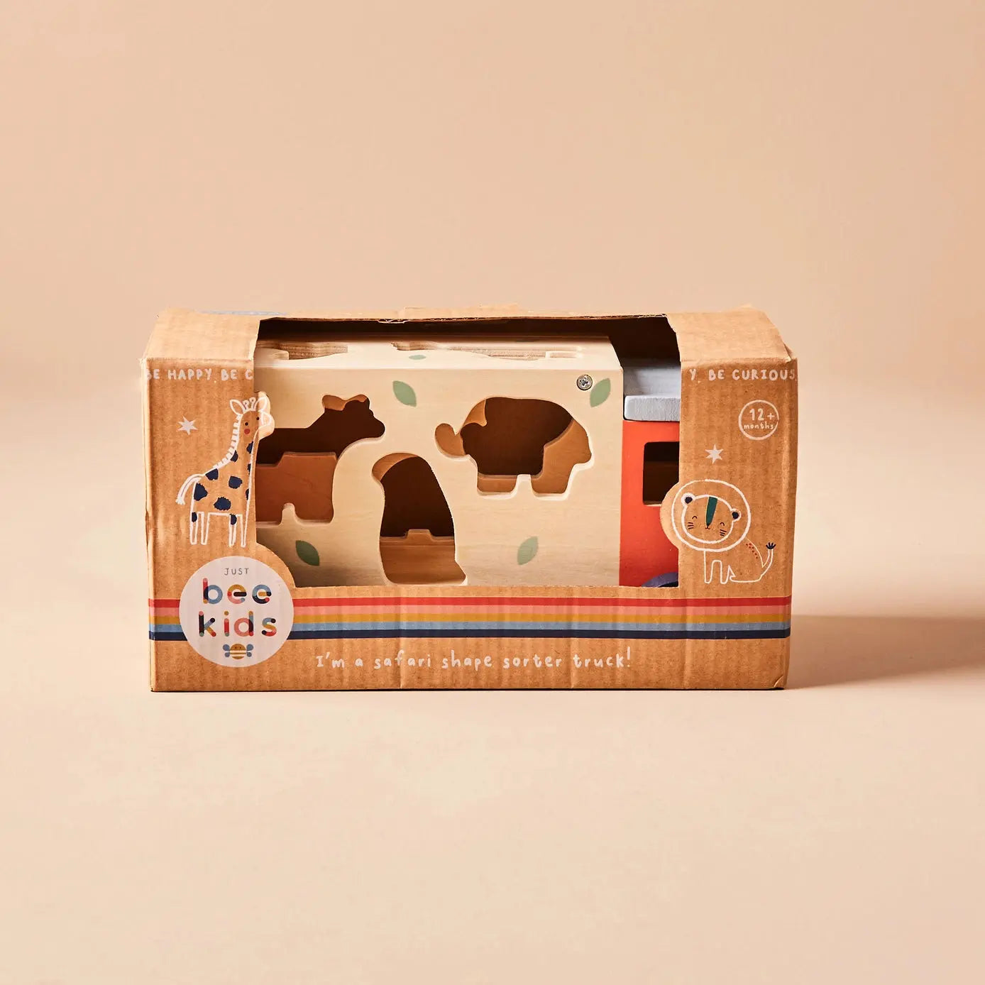 Box with wooden jeep toy with 'just bee kids' branding on a beige background