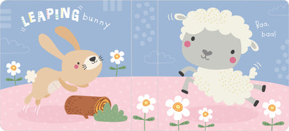 Children's book cover with a rabbit and sheep on a pink blanket with flowers.